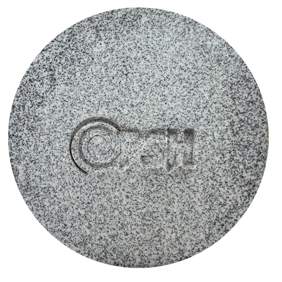 Round gray clay sample with a brand logo on a white background