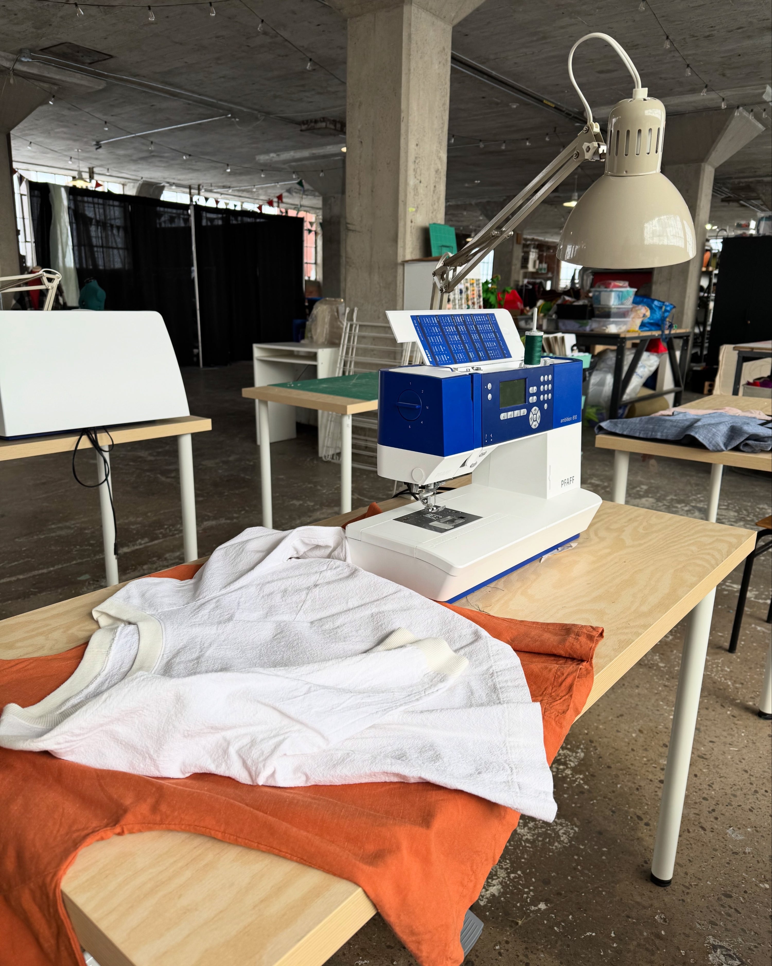 Sewing machine on a table with fabric in an industrial setting
